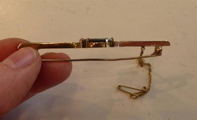 Lot 2020 - An Opal Bar Brooch, the flat oval opal in a six claw setting on a scroll shouldered bar brooch,...