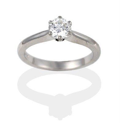 Lot 2026 - A Platinum Diamond Solitaire Ring, the round brilliant cut diamond in white claws to a tapered...