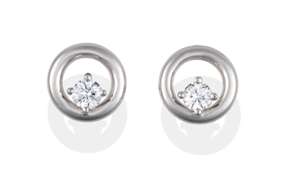 Lot 2030 - A Pair of 18 Carat White Gold Diamond Earrings, a round brilliant cut diamond claw set and...