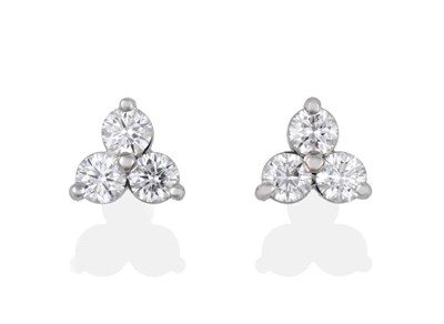 Lot 2032 - A Pair of 18 Carat White Gold Diamond Stud Earrings, trios of round brilliant cut diamonds in...