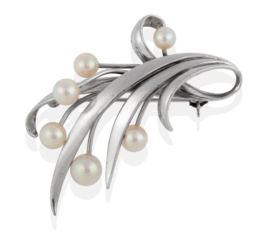 Lot 2037 - A Cultured Pearl Floral Spray Brooch, by Mikimoto, eleven white leaves terminating with six...
