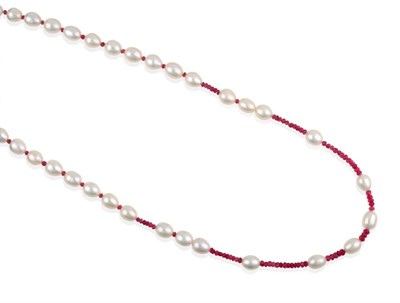 Lot 2038 - A Ruby and Cultured Pearl Necklace, faceted ruby beads spaced by cultured pearls, length 57cm...