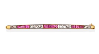 Lot 2050 - An Early 20th Century Ruby and Diamond Line Brooch, trios of calibré cut rubies, spaced by...