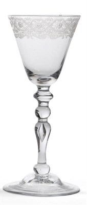 Lot 48 - A Newcastle Light Baluster Trick Wine Glass, circa 1750, the round funnel bowl engraved with an...