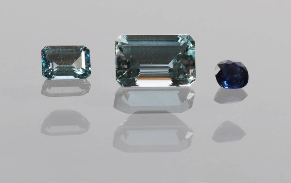 Lot 2053 - A Loose Cushion Cut Colour Change Sapphire, of 1.00 carat approximately and Two Loose Octagonal Cut