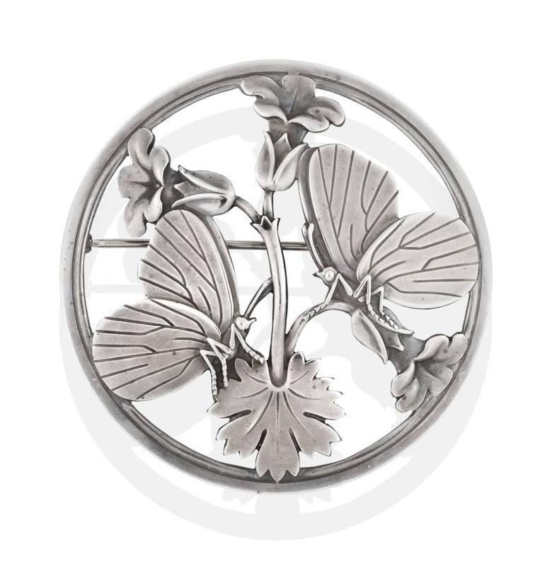 Lot 2063 - A Silver Brooch, by Georg Jensen, the round brooch with butterfly and floral motifs, numbered...