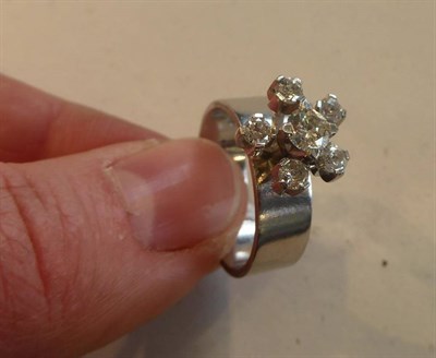 Lot 2069 - A Diamond Cluster Ring, a round brilliant cut diamond within a spaced border of mixed cut...