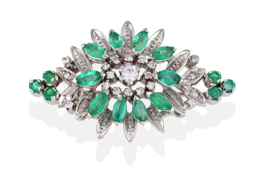 Lot 2073 - An Emerald and Diamond Brooch, the lozenge shape with round brilliant cut diamond centre, eight-cut