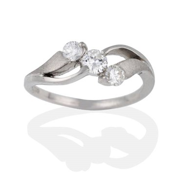 Lot 2077 - A Platinum Diamond Three Stone Ring, the round brilliant cut diamonds in double twist...