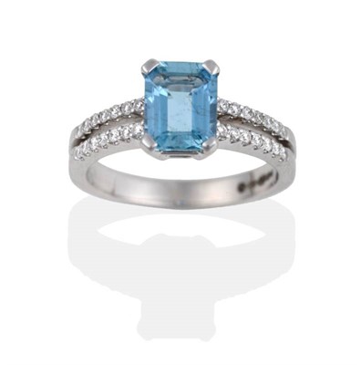 Lot 2078 - An 18 Carat White Gold Aquamarine and Diamond Ring, the emerald-cut aquamarine in a four claw...