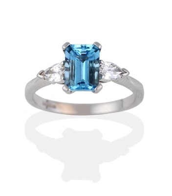 Lot 2080 - An 18 Carat White Gold Aquamarine and Diamond Three Stone Ring, the emerald-cut aquamarine...