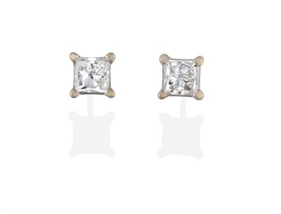 Lot 2082 - A Pair of Diamond Solitaire Earrings, princess cut diamonds in claw settings, total estimated...
