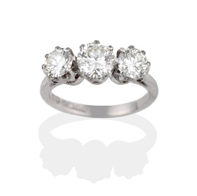 Lot 2089 - An 18 Carat White Gold Diamond Three Stone Ring, the graduated round brilliant cut diamonds in...