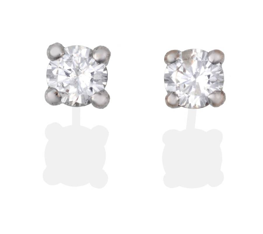 Lot 2090 - A Pair of 18 Carat White Gold Diamond Solitaire Earrings, the round brilliant cut diamonds in white