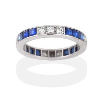 Lot 2099 - A Sapphire and Diamond Eternity Ring, trios of round brilliant cut diamonds and square calibré cut