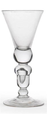 Lot 53 - A Heavy Baluster Wine Glass, circa 1700, the thistle bowl and solid base, upon an hollow acorn knop