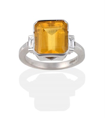 Lot 2101 - An 18 Carat White Gold Yellow Beryl and Diamond Ring, the emerald-cut beryl in a two part...