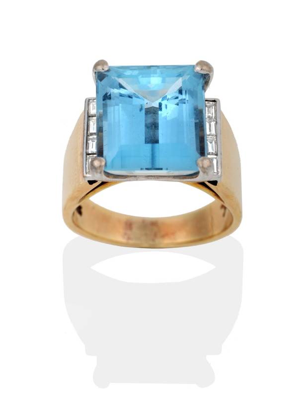 Lot 2117 - An Aquamarine and Diamond Ring, an octagonal cut aquamarine in a claw setting, to channel set...
