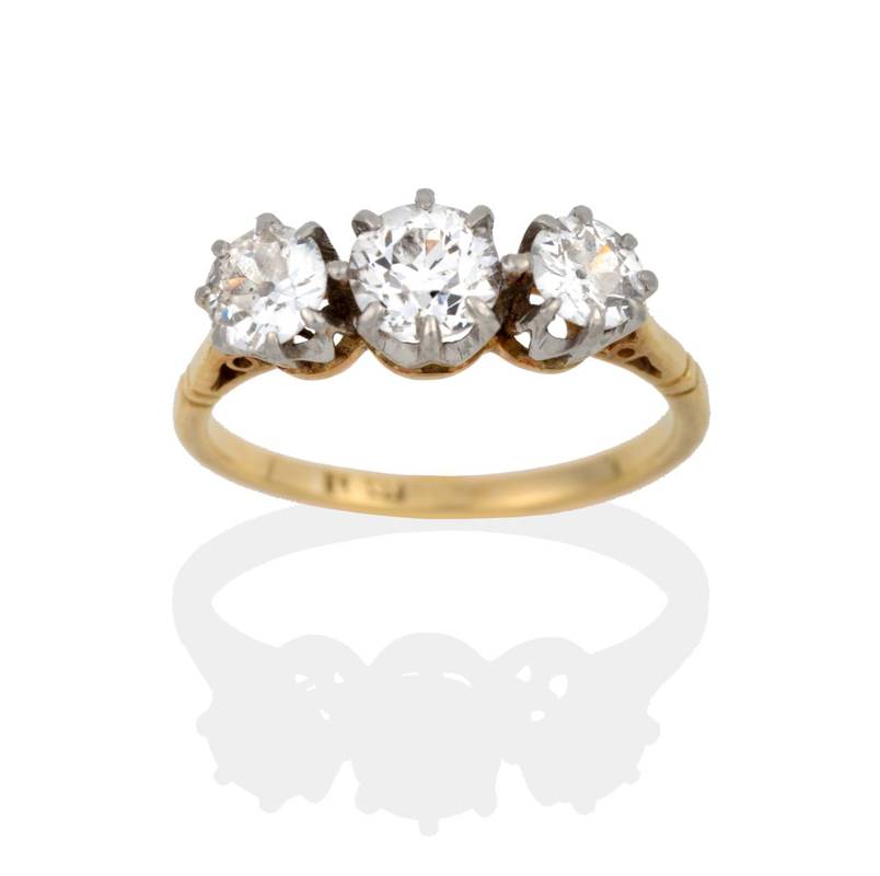Lot 2121 - A Diamond Three Stone Ring, the old cut diamonds in white claw settings, to a yellow tapered...