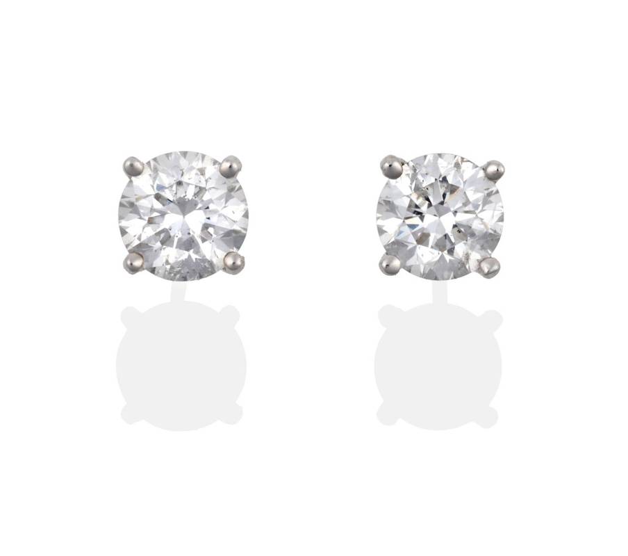 Lot 2125 - A Pair of 18 Carat Gold Diamond Solitaire Earrings, round brilliant cut diamonds in claw...