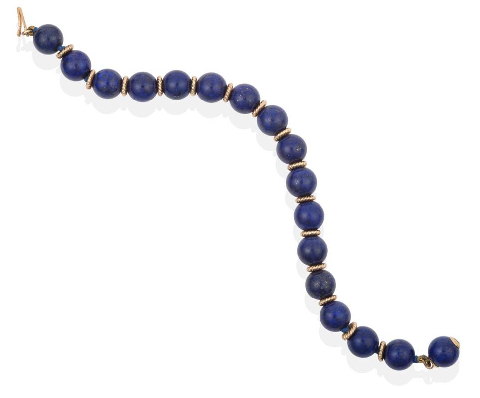 Lot 2129 - A Lapis Lazuli Bead Bracelet, by Tiffany, lapis lazuli beads spaced by rope motif spacers,...