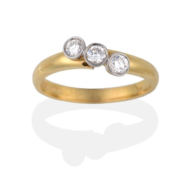Lot 2139 - An 18 Carat Gold Diamond Three Stone Twist Ring, the round brilliant cut diamonds in white...