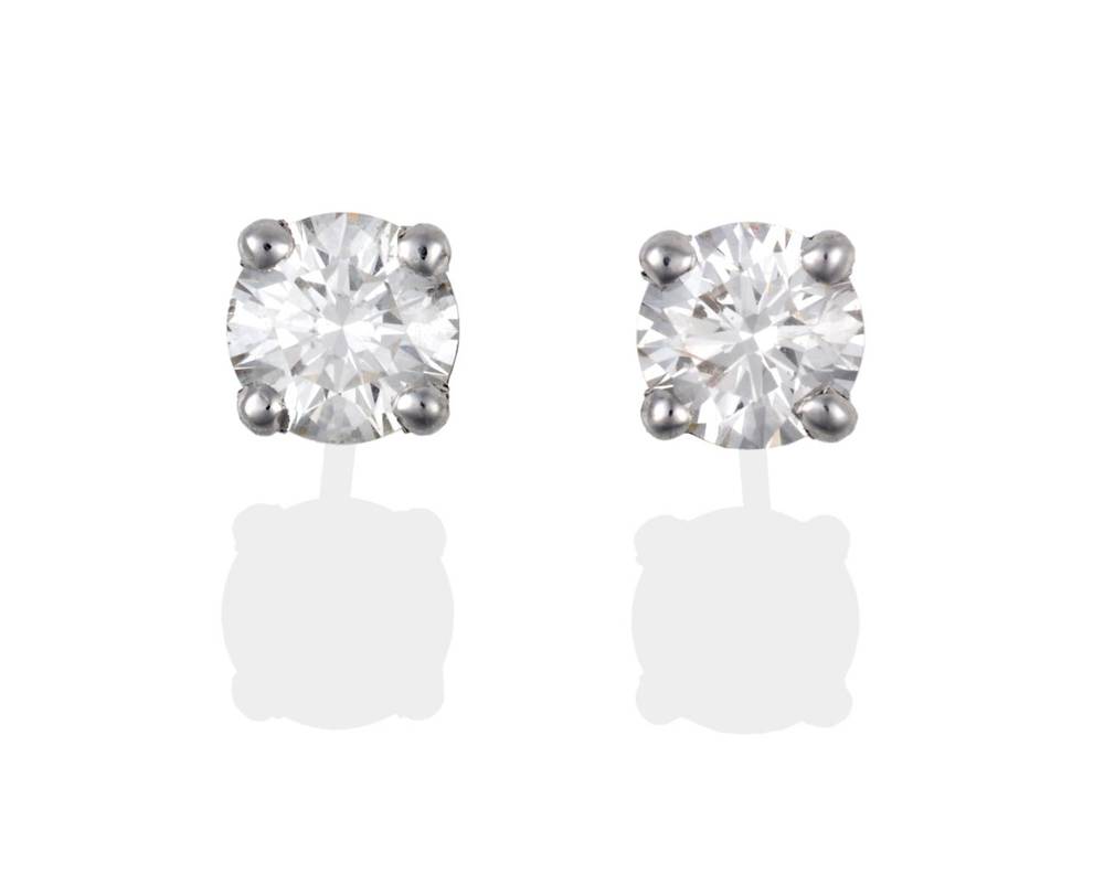 Lot 2092 - A Pair of 18 Carat White Gold Diamond Solitaire Earrings, round brilliant cut diamonds in claw...