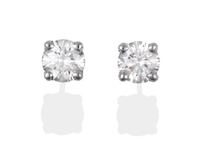 Lot 2092 - A Pair of 18 Carat White Gold Diamond Solitaire Earrings, round brilliant cut diamonds in claw...