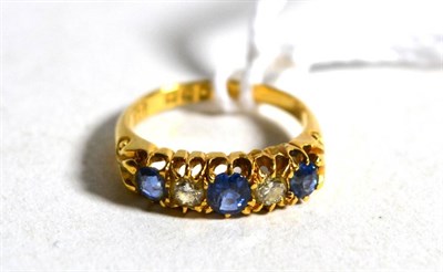 Lot 5 - An 18 carat gold Victorian sapphire and diamond ring, three round cut sapphires spaced by two...