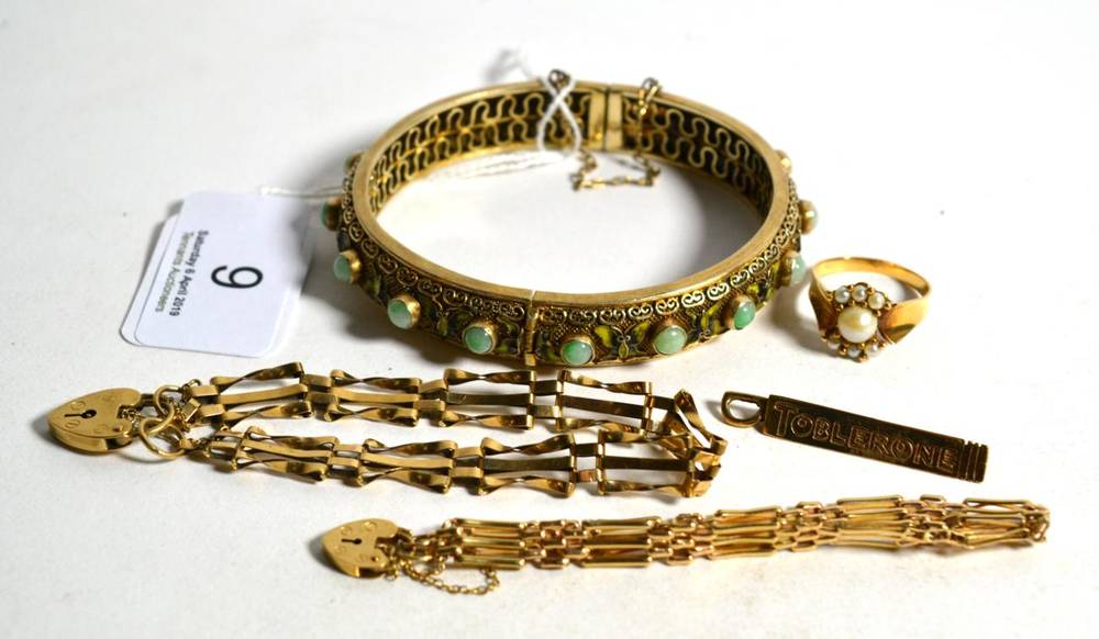 Lot 9 - A miniature 9 carat gold 'Toblerone' charm, length 4cm; two gate link bracelets with attached 9...