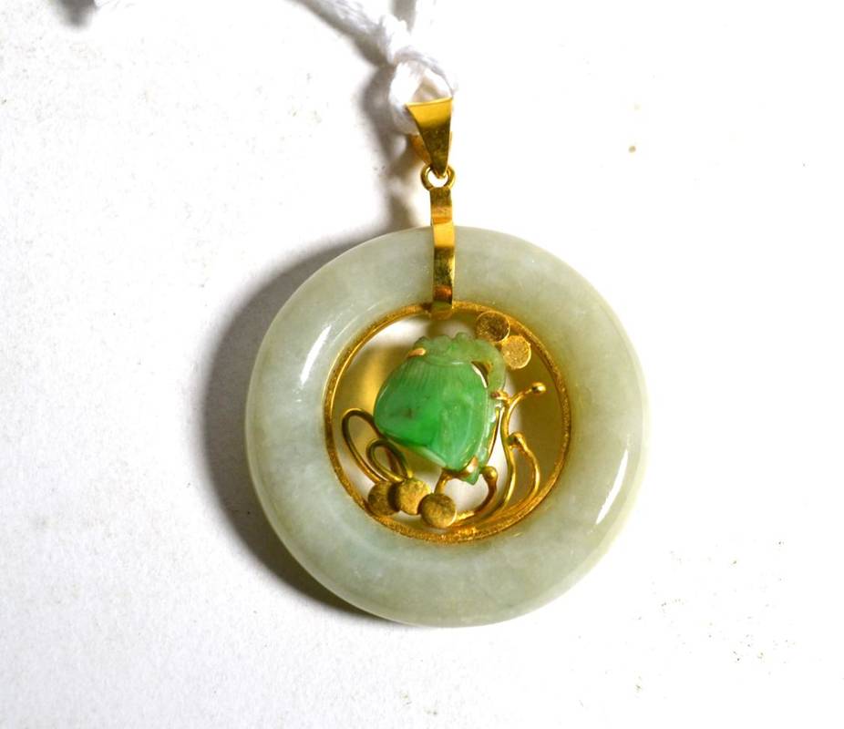 Lot 11 - A jade pendant, a carved jade flower head amongst vines within a circular jade bi-disc,...