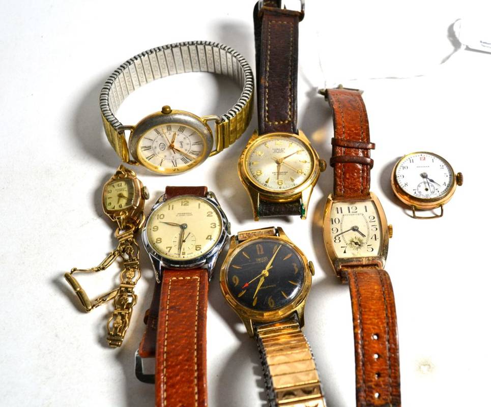 Lot 15 - A 9 carat gold tonneau shaped wristwatch; a lady's 9 carat gold bracelet wristwatch; a rolled...