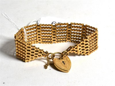 Lot 65 - A gate link bracelet with an attached 9 carat gold heart shaped padlock clasp, length 18cm