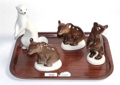 Lot 102 - Four Russian porcelain models, an ermine and three bear cubs