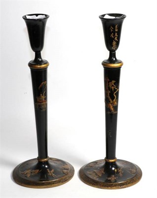 Lot 106 - A pair of wooden Oriental candlesticks