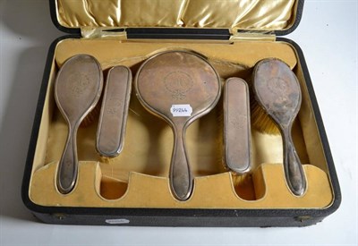 Lot 190 - A five piece silver brush and mirror set, by Walker & Hall, Sheffield 19, engraved 'M', cased