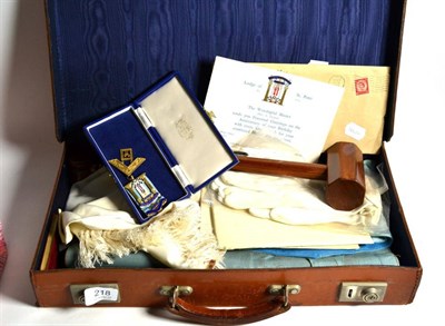 Lot 218 - A leather case containing assorted Masonic memorabilia including a silver and enamel jewel,...