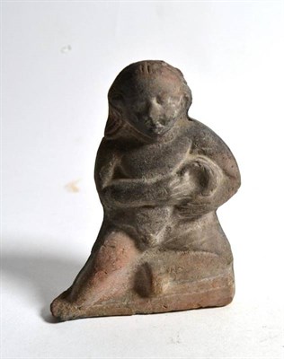 Lot 232 - A Romano Egyptian or Greek terracotta figure holding a vessel, 2nd century BC-AD, modelled in...