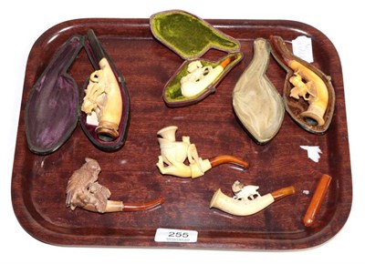 Lot 255 - A group of late 19th century Meerschaum pipes, carved with various designs some with amber...