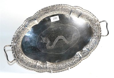 Lot 290 - An Oriental white metal twin handled tray, indistinct character marks, shaped oval, engraved to the