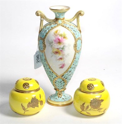 Lot 296 - A Royal Worcester reticulated vase, with hand-painted floral panels and scrolled handles, the...