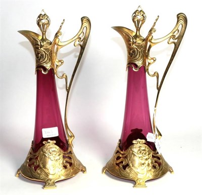 Lot 314 - A pair of WMF style claret jugs, after original 1906 design, gilt finish, cranberry glass with...