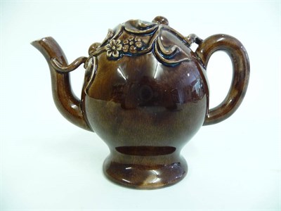Lot 127 - A Brameld Treacle Glaze Pottery Cadogan Teapot, circa 1830, of traditional form, applied with...