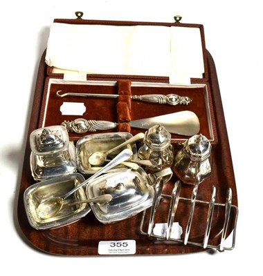 Lot 355 - A selection of silver items consisting of three peppers; three salts; three salt spoons; a...