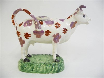 Lot 133 - A Cambrian Pottery Cow Creamer, circa 1830, the animal standing four square with pink lustre...