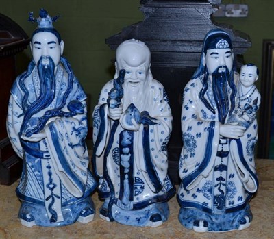 Lot 391 - Three 20th century Chinese blue and white porcelain figures of sages, tallest 39cm