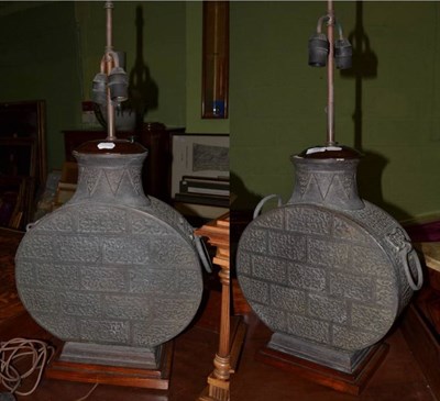 Lot 392 - A pair of 20th century Chinese patinated metal table lamps, cast as twin ring-handled moon flasks