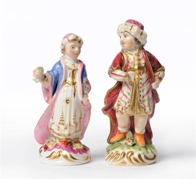 Lot 135 - A Rockingham and a Derby Porcelain Models of Turks, circa 1830, he standing in turban and...