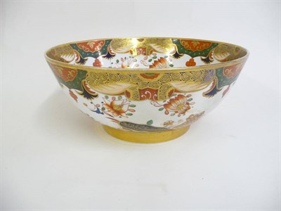 Lot 136 - A Spode Porcelain Punch Bowl, circa 1810, painted in the Imari palette with a fenced garden...