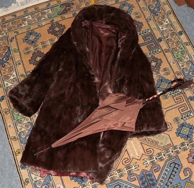 Lot 1101 - A brown fur jacket, a Paragon parasol and a stole (3)